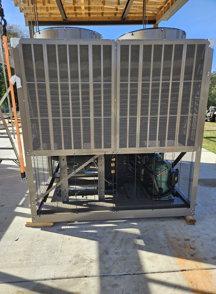 Using our I-beam trolley system to unload an air-cooled chiller
